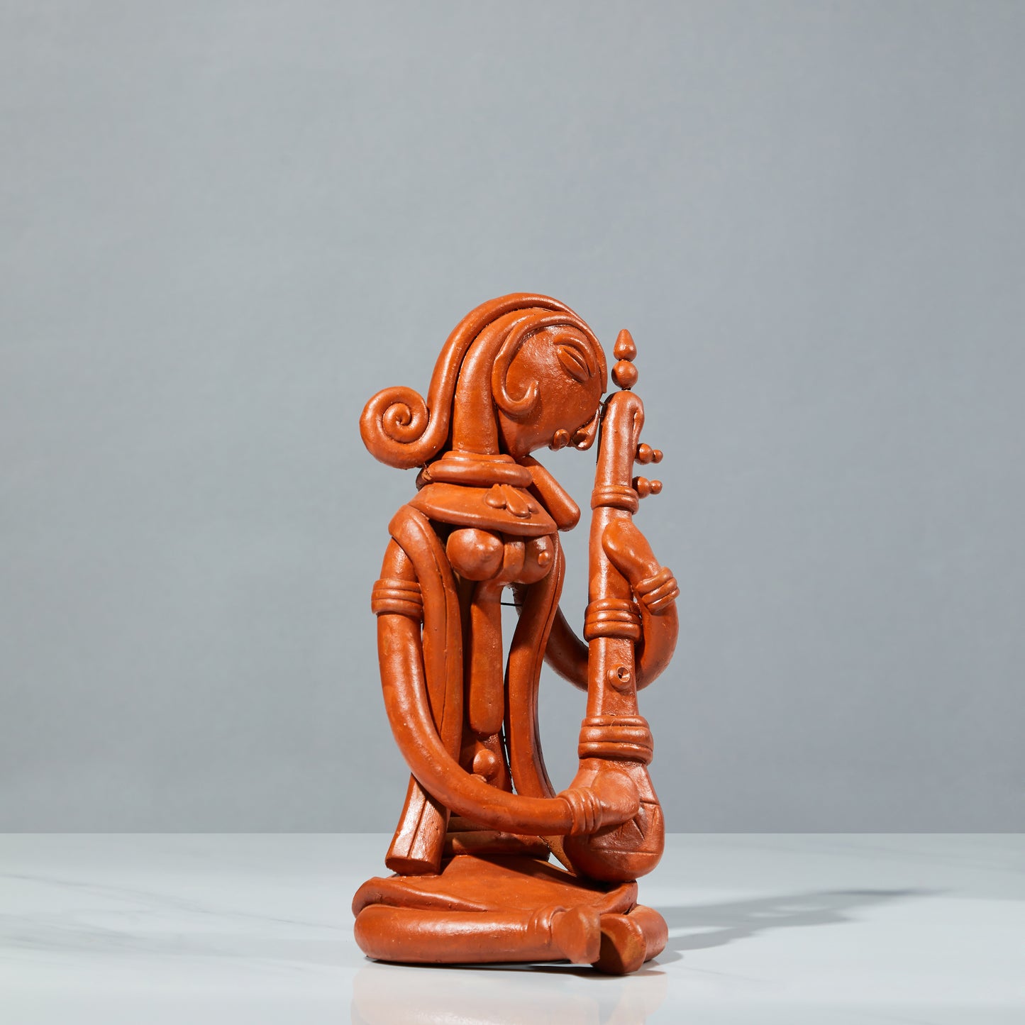 Terracotta sculpture, terracotta decor, saraswati playing veena, angled view