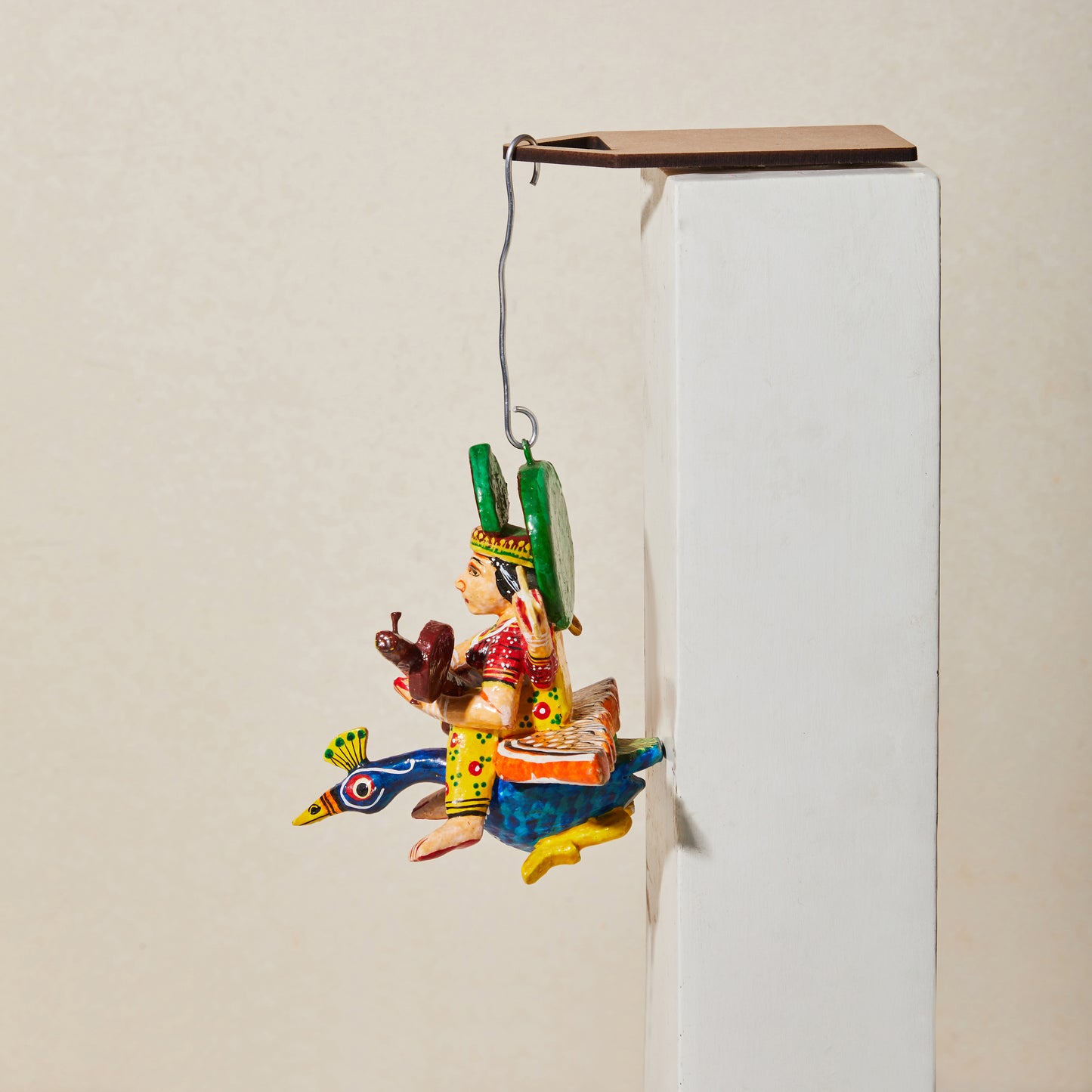 Flying Gods of Varanasi—sarawasti riding on a peacock, varanasi toy, hanging god, cabinet curio, front view.