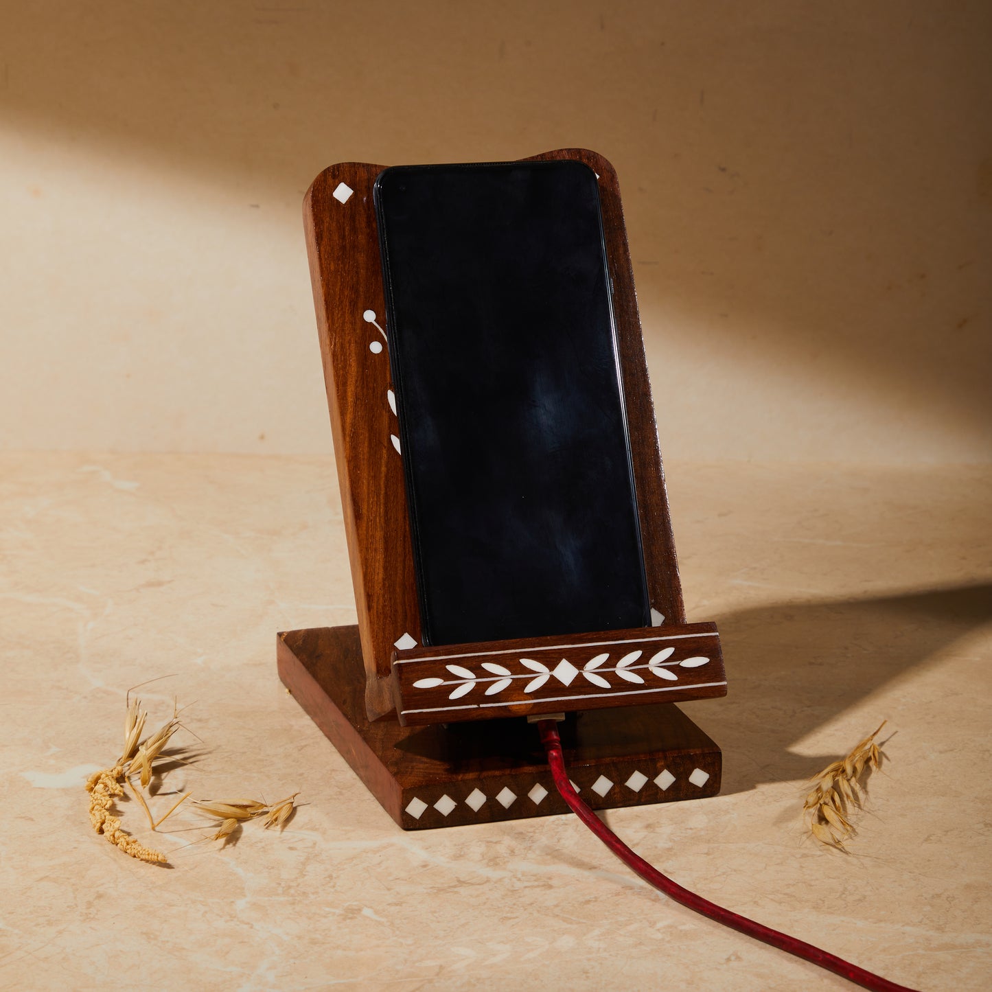 Wooden Inlay Adjustable Phone Stand with Charging Slot, phone holder, tabletop organiser, phone charging unit, side view showing phone kept on the holder and wire connected.