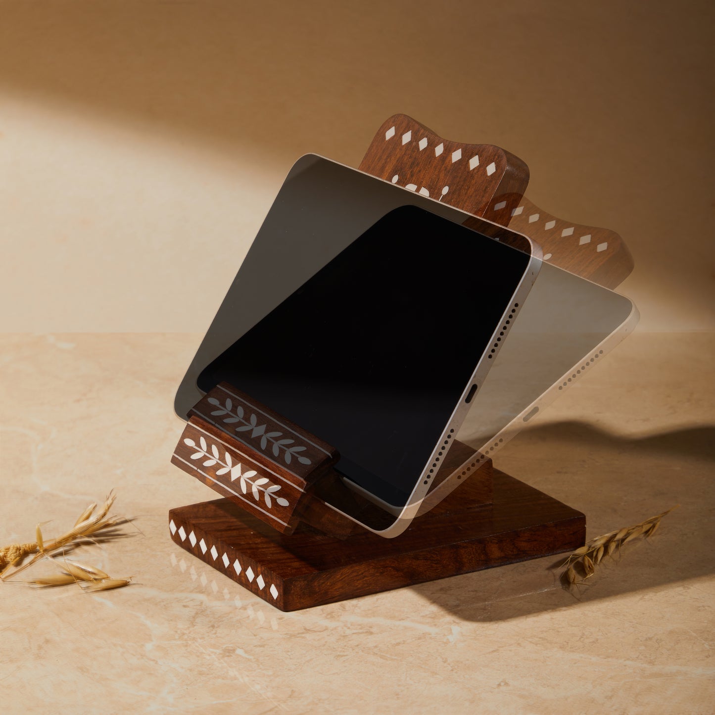Wooden Inlay Adjustable Phone Stand with Charging Slot, phone holder, tabletop organiser, phone charging unit, side view showing table placed on the holder and that it can be adjusted