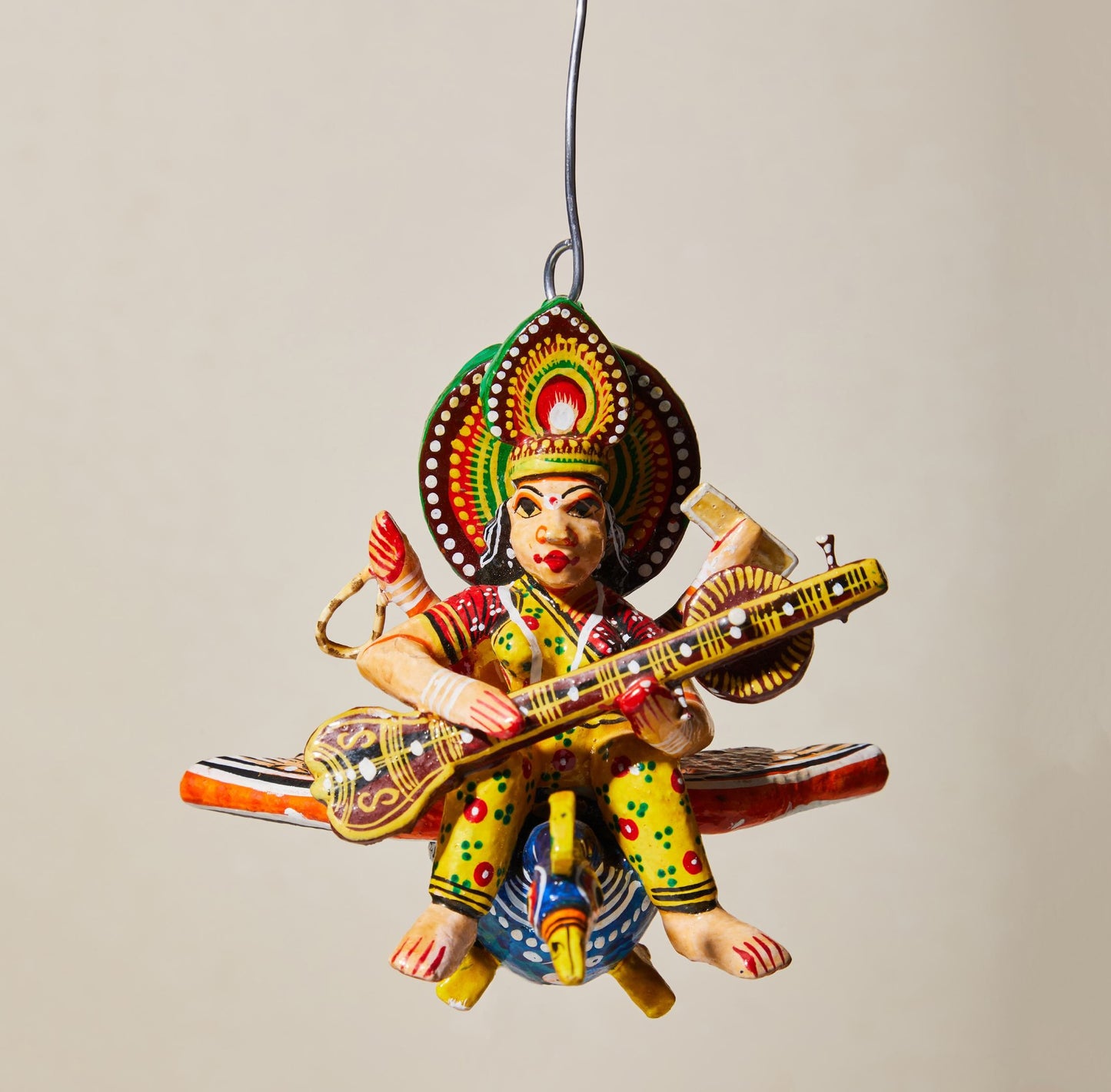 Flying Gods of Varanasi – Saraswati riding on a Peacock