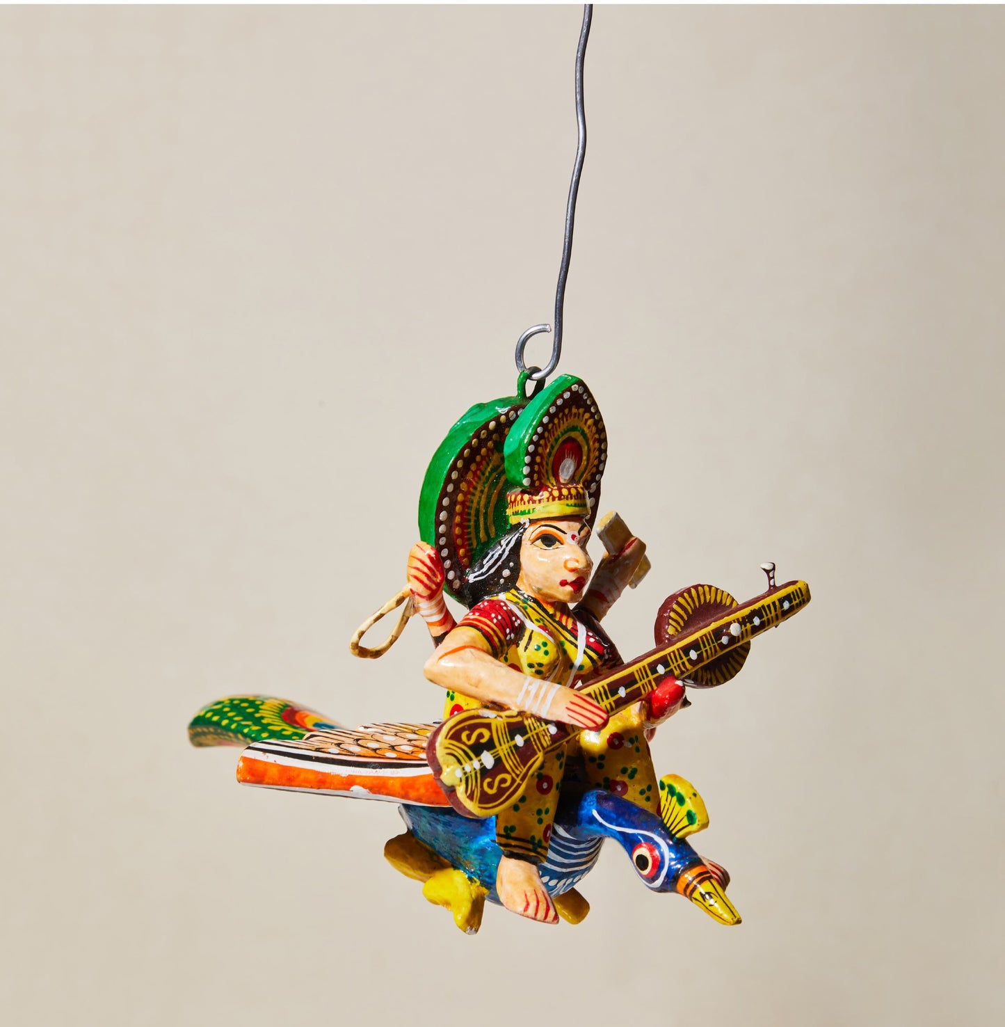 Flying Gods of Varanasi – Saraswati riding on a Peacock